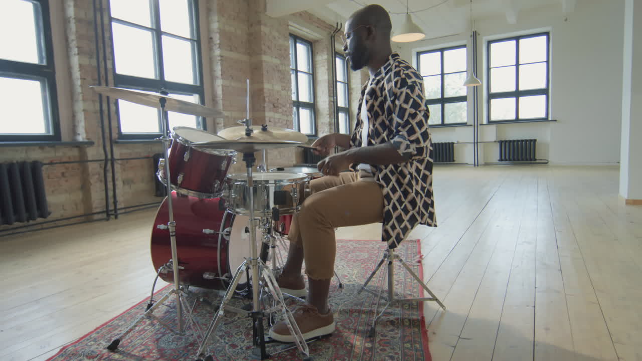Black Drummer Playing Drumkit in Studio