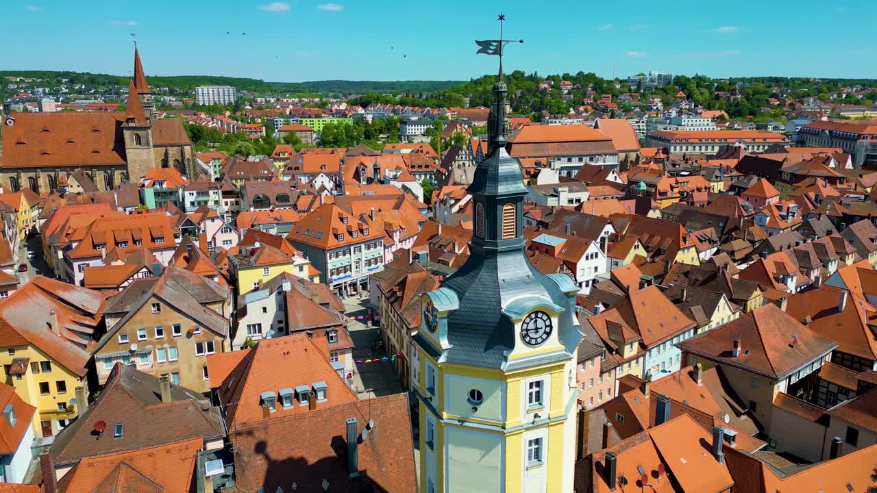 4K Aerial Drone Video of the Historic Herrieder Clock Tower and the St. Johannis Church in the Old Town area of Downtown Ansbach, Germany