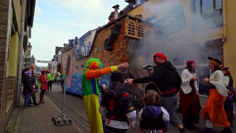 happy german families dressed in funny costumes dancing on street parade rose monday carnival