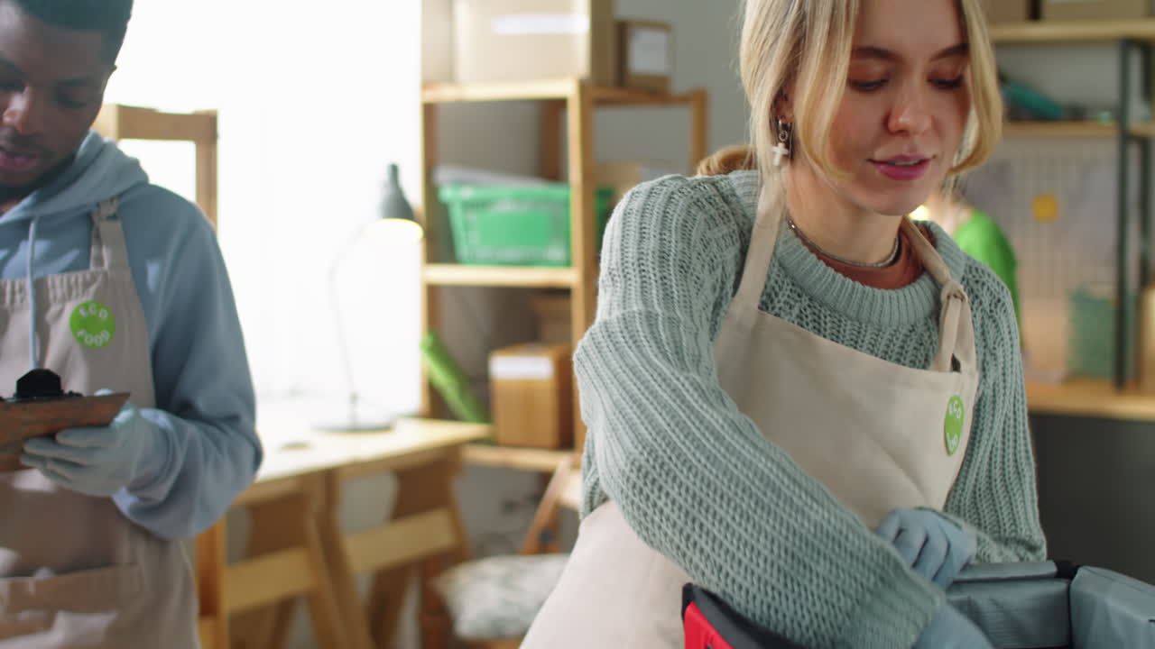 Young Diverse Colleagues Packing Eco Food Orders for Delivery