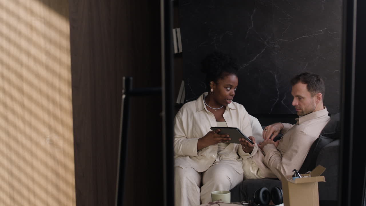 Couple looking at a tablet in a mirror reflection