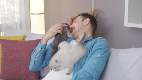 the man holds the kittens on his chest and loves to caress them.