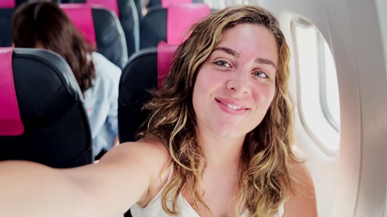Woman Looking Out Airplane Window, Santorini Views Ahead