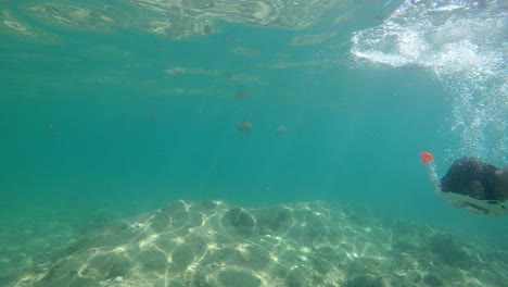 Young-man-snorkeling-in-mediterranean-sea