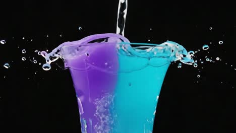 colorful liquid pouring and splashing in a glass