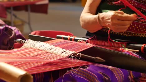 woman weaving traditional textile on a loom