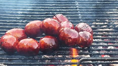 spicy chorizo sausages on a smoky bbq grill, cooking meat on a hot grill with fire during summer, delicious food, 4k shot