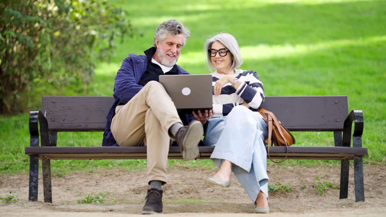 Senior Couple Using Laptop in Park