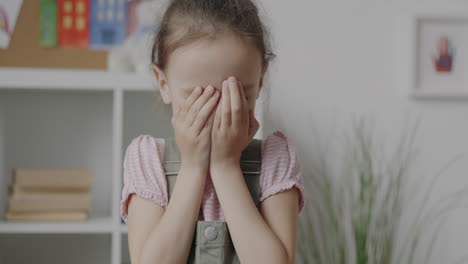 a playful girl hiding her face