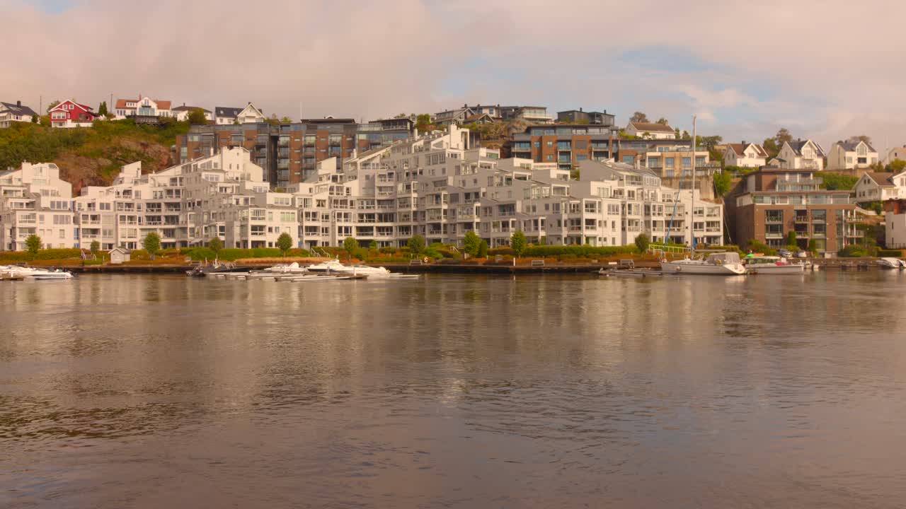 Coastal cityscape of Kristiansand, Norway with boats and buildings