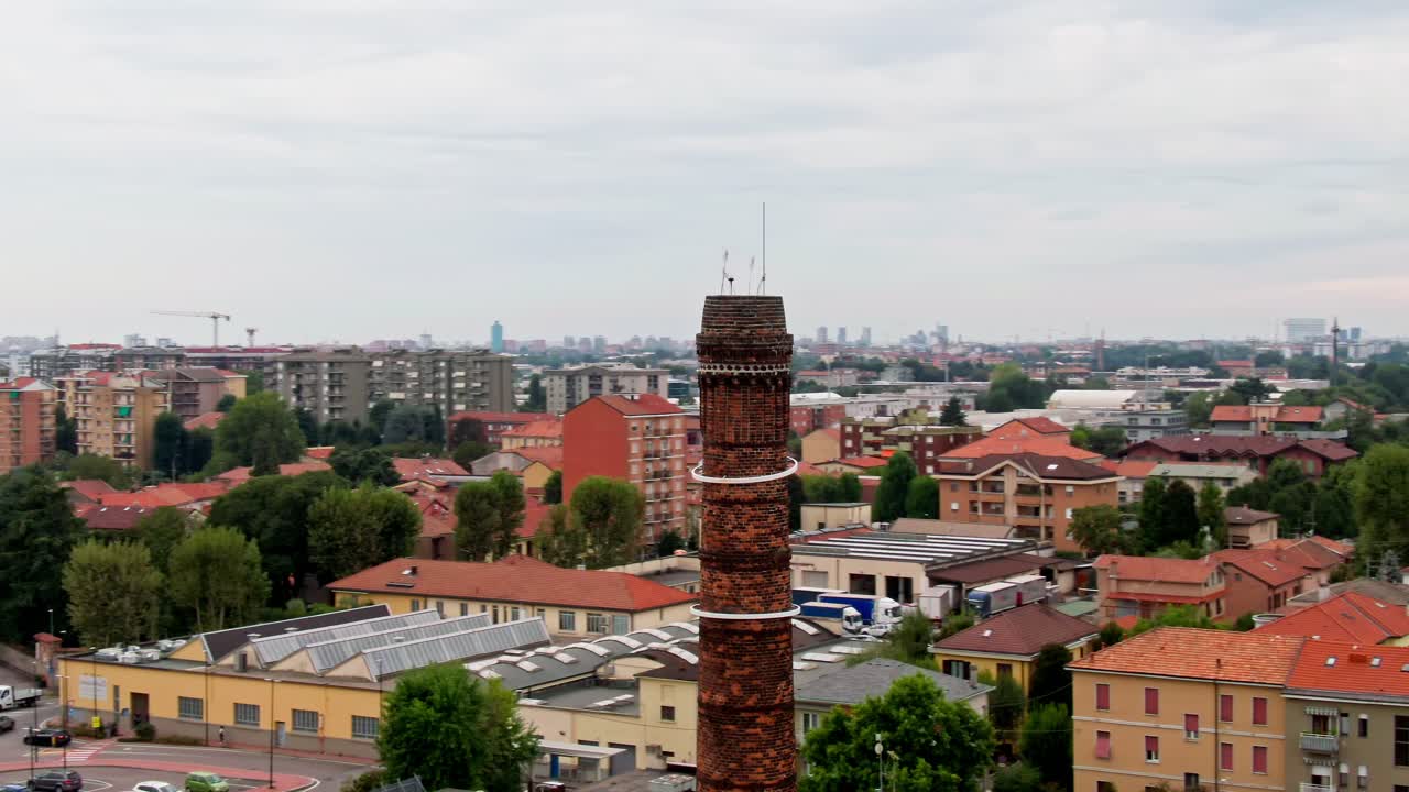 Aerial orbit around an industrial chimney in Milan, Italy