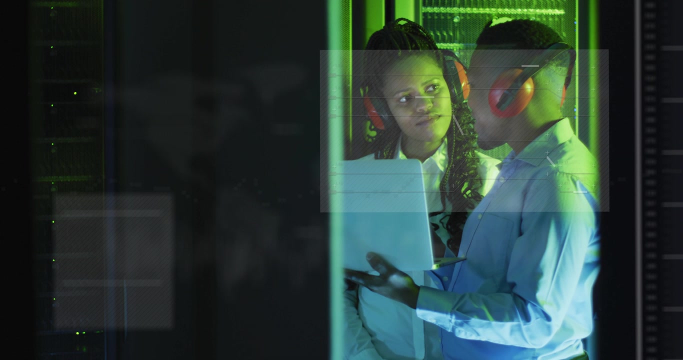 Male tech tapping tablet female tech observing activating UI charts floating over hands monitoring