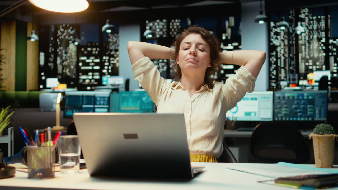 Vertical Video Pleased businesswoman enjoys a quiet moment of downtime in a corporate setting