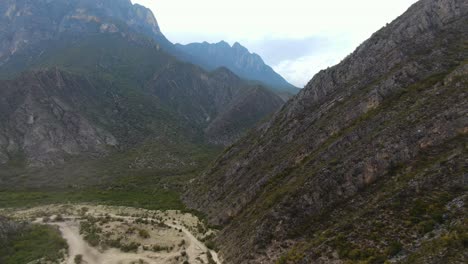 beautiful valley of la huasteca park in mexico with riverbed under high rocky mountains