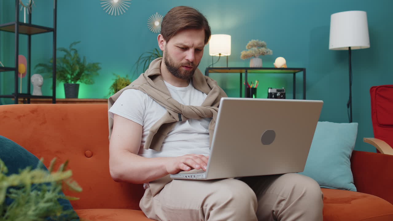 Amazed young man use laptop computer receive good news message shocked by victory celebrate win