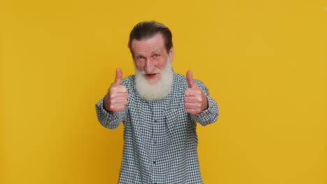 senior man raises thumbs up agrees or gives positive reply recommends advertisement likes good idea
