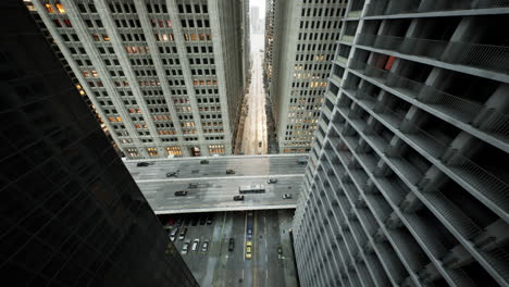 Aerial-hyperlapse-of-busy-car-traffic-in-between-Skyscrapers-city-center