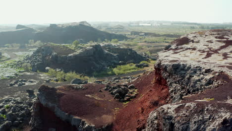 Orbit-rotation-drone-view-turning-around-beautiful-rock-cliff-in-Iceland.-Aerial-view-birds-eye-showing-stony-hills-and-mountain