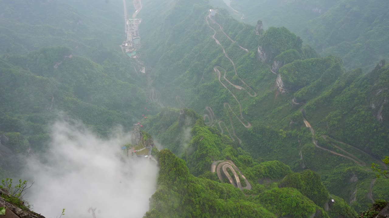 Green and foggy landscape of 99 Heaven bends road, Tianmen Mountain