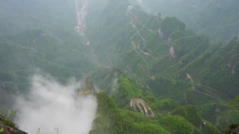 green and foggy landscape of 99 heaven bends road, tianmen mountain