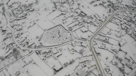 aerial view of snow covered town on a gloomy and hazy day