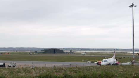 shot of an airplane starting its engines after being loaded with baggage