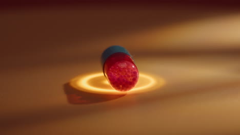 red and blue vitamin antibiotics drugs pill isolated rotate with golden light energy healinghealthcare, pharmaceutical industry, drug use, macro close up