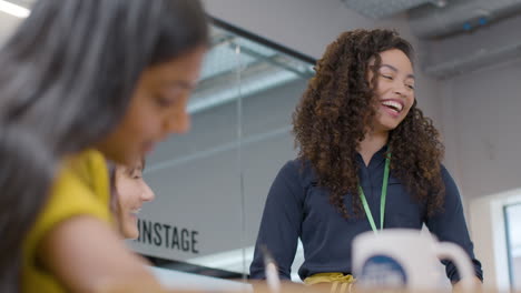 happy businesswoman presenting to group of colleagues