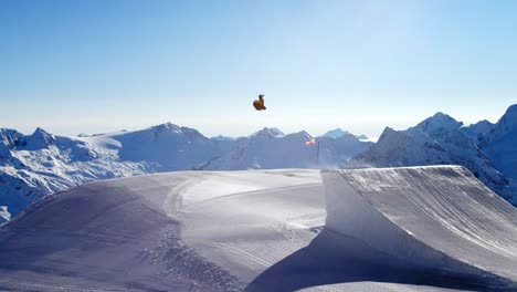 amazing snowboard backflip trick on a big air snowboard jump with beautiful mountain view