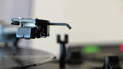 vinyl record player spinning on vintage vinyl turntable player and being stopped by a woman hand