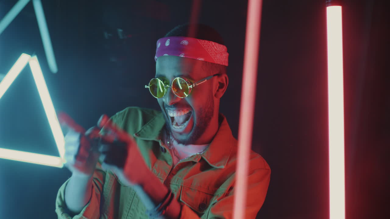Stylish Man Posing with Neon Lights