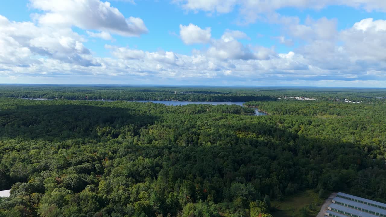 Clouds Fill The Sky Over Lush Forest By Gull Lake In Gravenhurst, Muskoka, Canada. Aerial Flyover