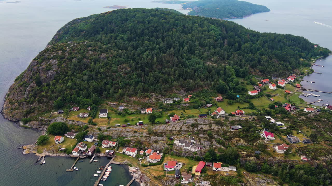 Small Village By The Mountainside In Brattön, Sweden - aerial shot