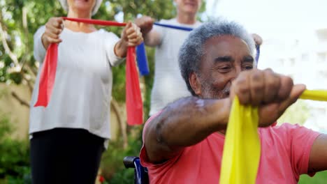 senior friends exercising with resistance band 4k