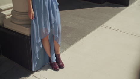 A-young-Caucasian-woman-with-long-brunette-hair,-plays-with-her-blue-mesh-skirt