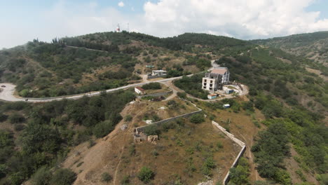 aerial view of a mountain landscape with roads, buildings, and construction sites