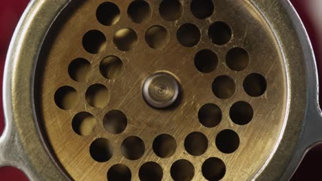 close-up of a meat grinder's grinding plate