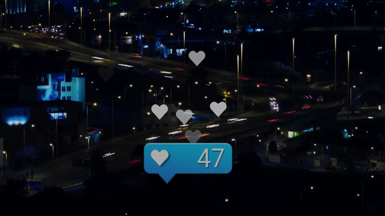 Hearts and likes animation over busy city highway at night