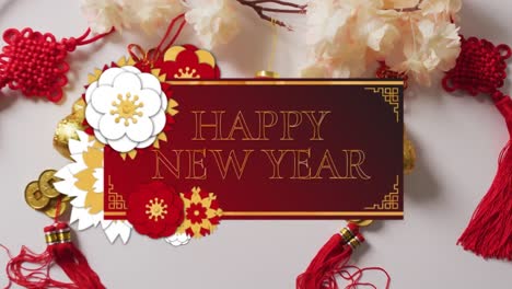 animation of new year greetings text over chinese traditional decorations on white background