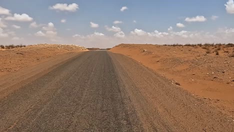 Driving-along-desert-road,-car-driver-pov