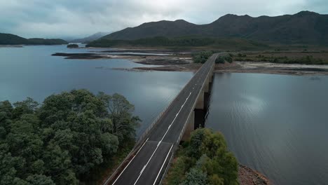 Profile-view-of-empty-bridge-over-Lake-Burbury-in-Tasmania,-Australia-during-morning