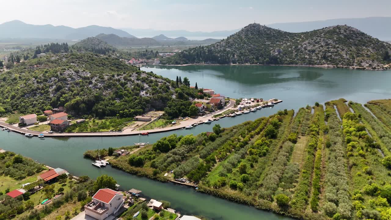 Drone turn over hill in Rogotin, with two river channels in site. Neretva valley in Croatia