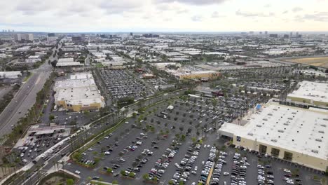 city of tustin, aerial view over building and parking lot of cars