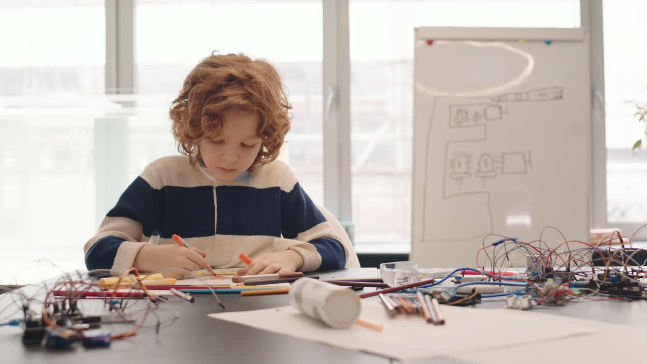 Ginger Schoolboy Drawing in Classroom