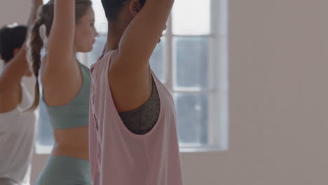 yoga-class-multi-ethnic-women-practicing-tree-pose-enjoying-healthy-lifestyle-exercising-in-fitness-studio-at-sunrise