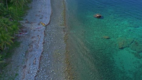 a tropical white sandy beach with crystal clear turquoise waters, gently brushing a long coastline with mountains and jungle