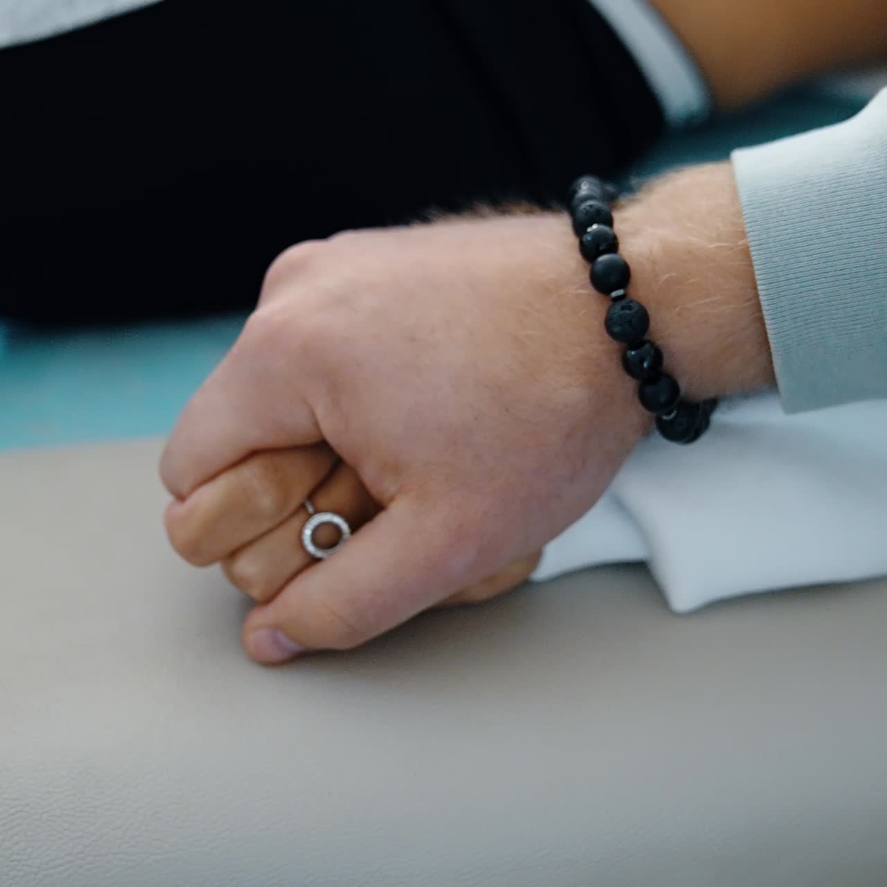 Beautiful female hand lies on the hospital couch. Male hand takes the female ones showing support. Close up