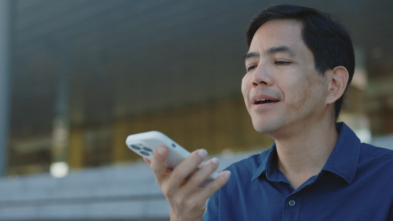 Man using a smartphone voice assistant