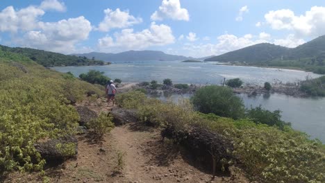 hikers coming back from the bubbly pool on jost van dkye island in the british virgin islands