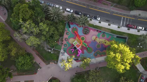 aerial top down shot of park with playground and playing kids in buenos aires,argentina